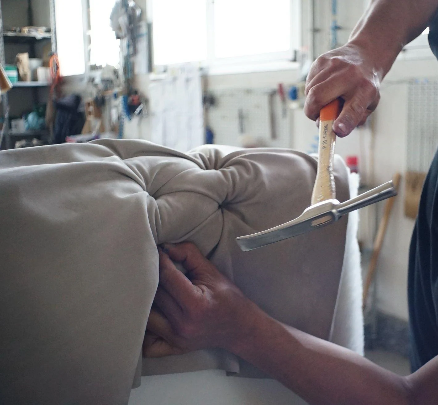 Hand-finishing tufted sofa upholstery in the HANRAN HOME workshop